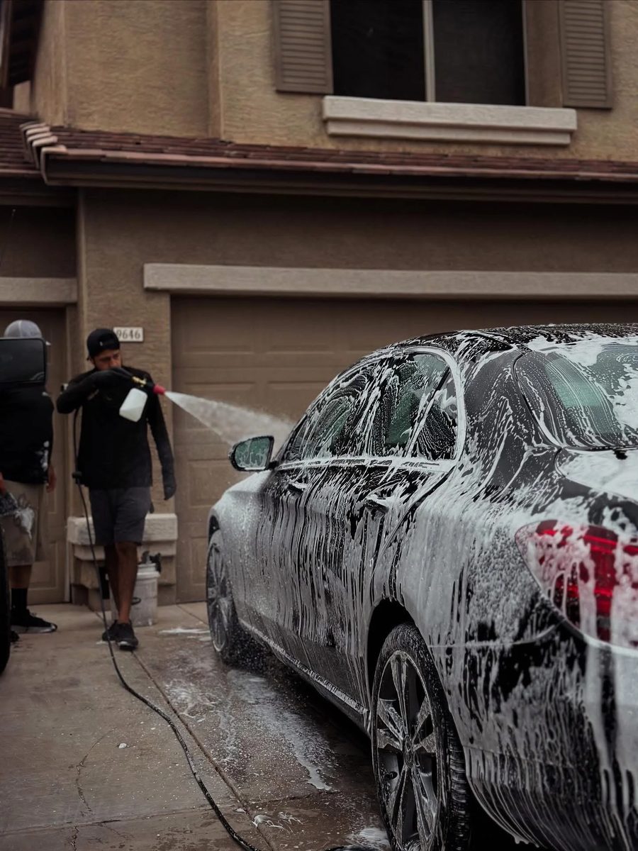 Josh applying foam to a customer car in a Phoenix Valley driveway